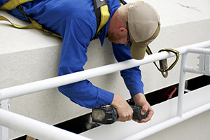 GutterItUp-employee-installing- comercial gutters